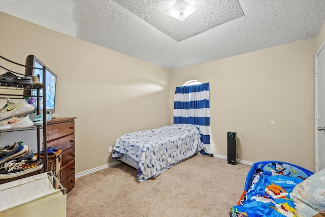 bedroom featuring carpet floors and a textured ceiling