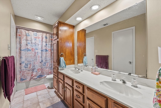 bathroom with toilet, a shower with curtain, tile patterned floors, vanity, and a textured ceiling