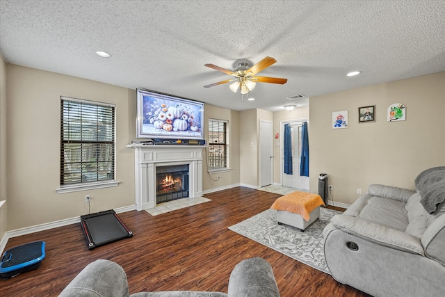 living room featuring wood-type flooring and a textured ceiling