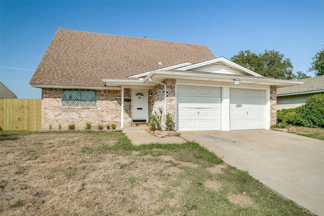 ranch-style house featuring a front lawn and a garage