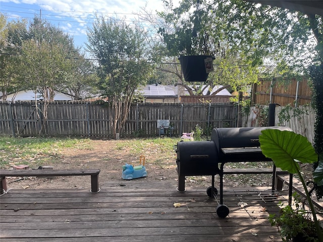 wooden deck featuring a grill