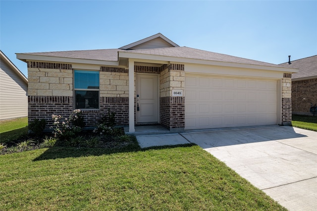 ranch-style house featuring a garage and a front lawn