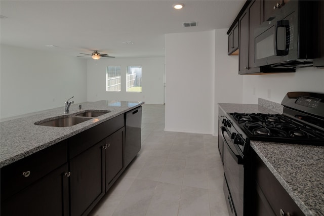 kitchen with ceiling fan, gas stove, sink, light stone counters, and stainless steel dishwasher