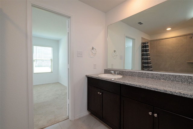 bathroom with a shower with curtain, vanity, and tile patterned flooring