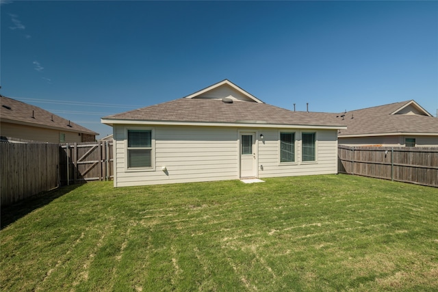 rear view of house with a yard