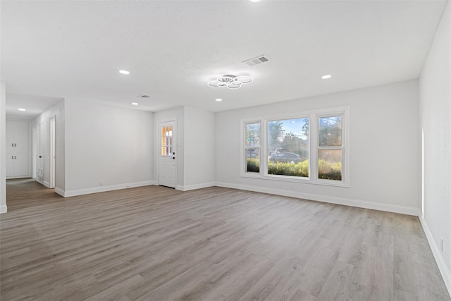 233 Oak Dr E, Hurst, TX 76053 - unfurnished living room featuring light wood-style floors, baseboards, and recessed lighting
