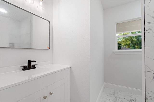 233 Oak Dr E, Hurst, TX 76053 - bathroom with marble finish flooring, vanity, and baseboards