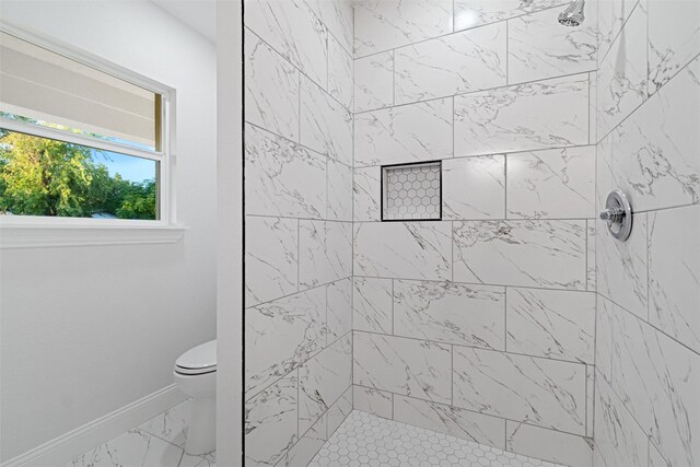 233 Oak Dr E, Hurst, TX 76053 - bathroom featuring marble finish flooring, tiled shower, baseboards, and toilet
