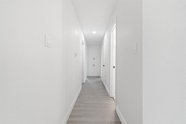 233 Oak Dr E, Hurst, TX 76053 - hall featuring baseboards, light wood-style floors, and recessed lighting