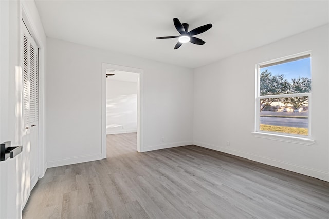 unfurnished bedroom with ceiling fan, connected bathroom, light hardwood / wood-style floors, and a closet