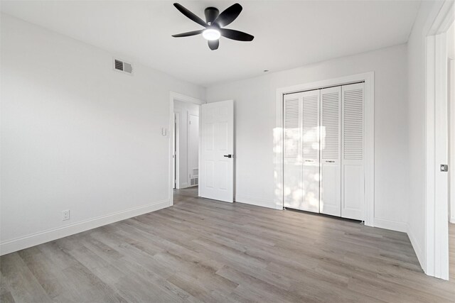 233 Oak Dr E, Hurst, TX 76053 - unfurnished bedroom with light wood-type flooring, a closet, and baseboards