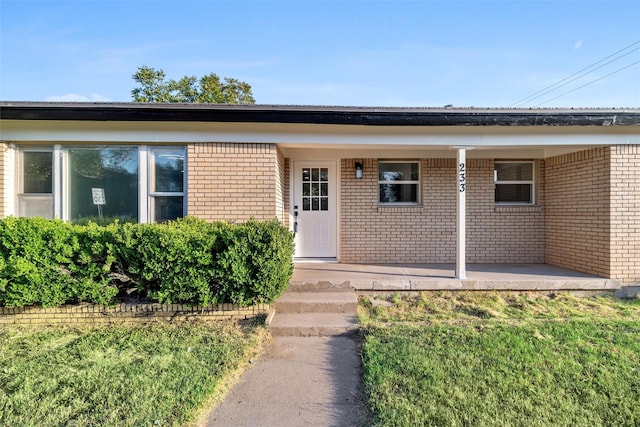 233 Oak Dr E, Hurst, TX 76053 - doorway to property featuring brick siding and a porch
