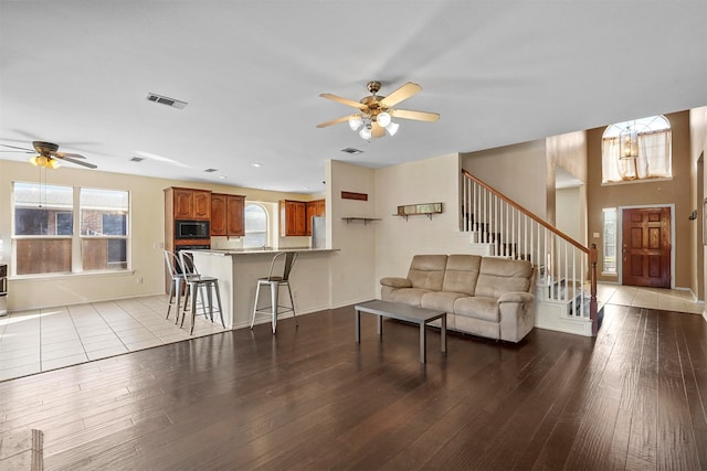 living room with ceiling fan and light wood-type flooring