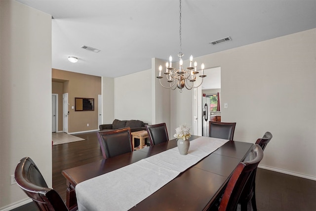 dining room with a chandelier and dark hardwood / wood-style flooring