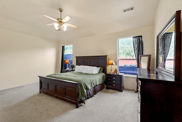 bedroom featuring light colored carpet and ceiling fan