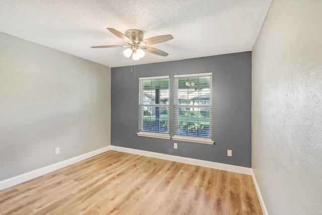 unfurnished room with light hardwood / wood-style floors, a textured ceiling, and ceiling fan