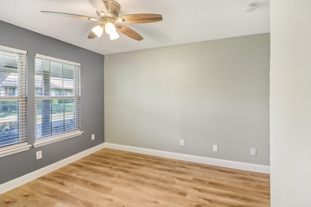 unfurnished room with ceiling fan, hardwood / wood-style floors, and a textured ceiling