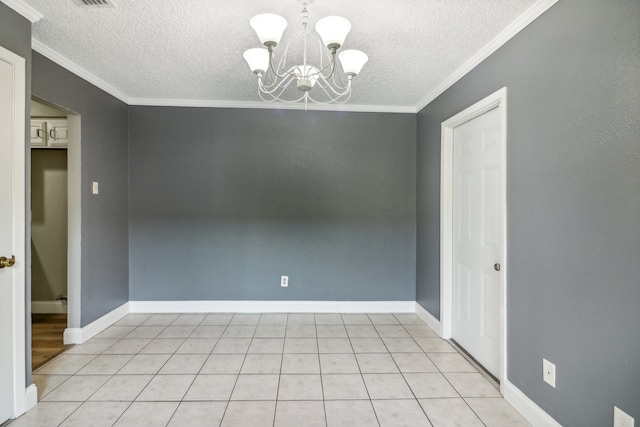 spare room featuring an inviting chandelier, crown molding, a textured ceiling, and light tile patterned flooring