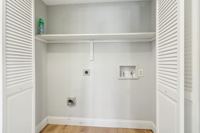 clothes washing area with washer hookup, a textured ceiling, hardwood / wood-style floors, and hookup for an electric dryer