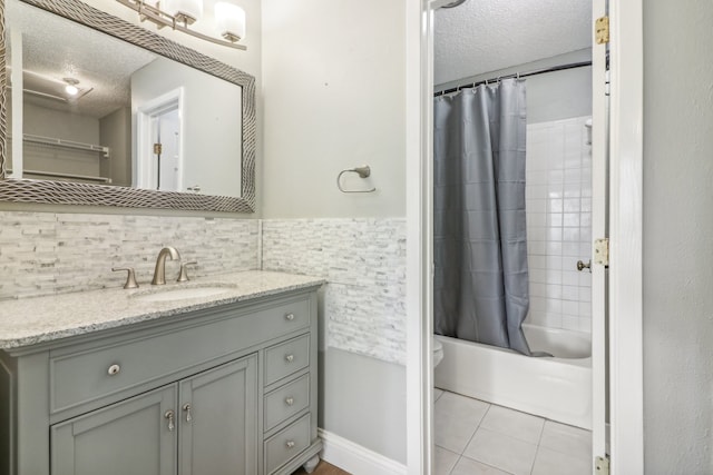 full bathroom with shower / tub combo, tile patterned floors, vanity, and a textured ceiling