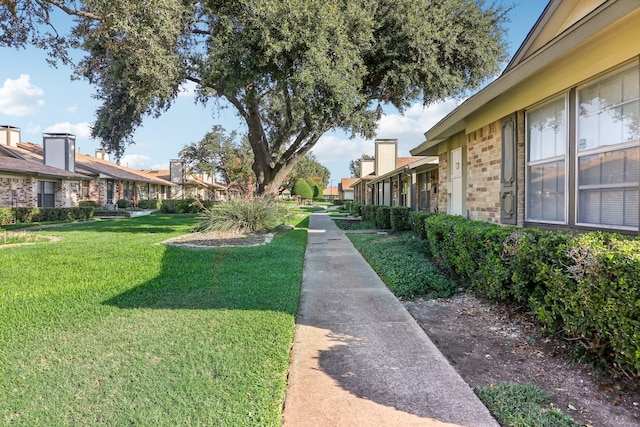 view of home's community featuring a lawn