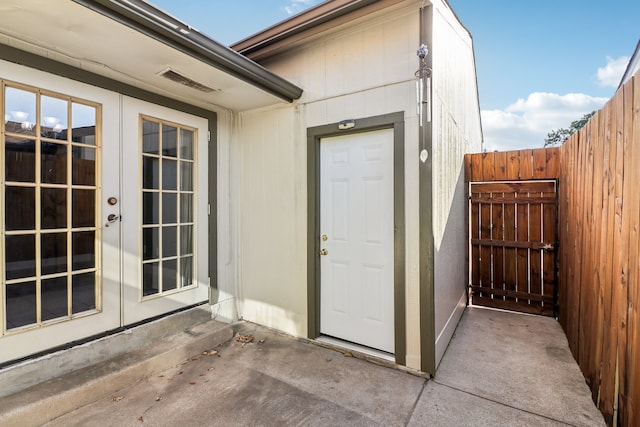 view of exterior entry featuring a patio