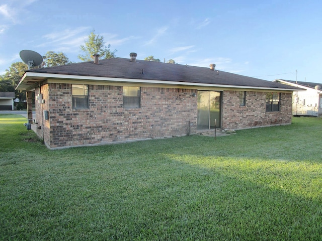 rear view of property with a yard