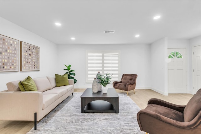 living room featuring baseboards, wood finished floors, visible vents, and recessed lighting
