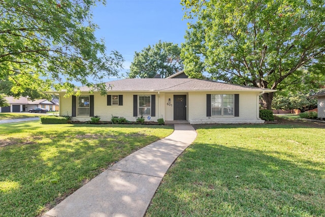 ranch-style home with a front lawn and brick siding