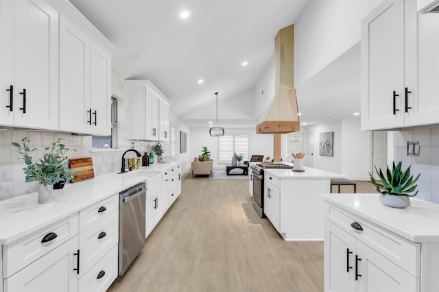 kitchen featuring white cabinetry, island exhaust hood, stainless steel appliances, backsplash, and a center island