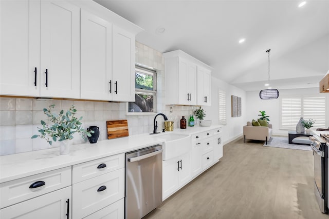 kitchen featuring decorative backsplash, sink, white cabinets, and stainless steel appliances