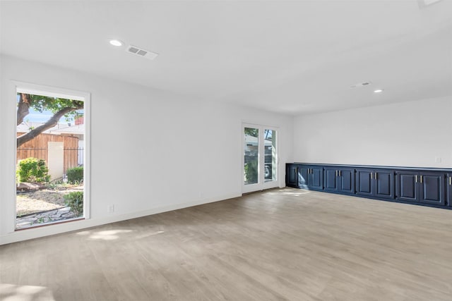 unfurnished room featuring light wood-type flooring, baseboards, visible vents, and recessed lighting