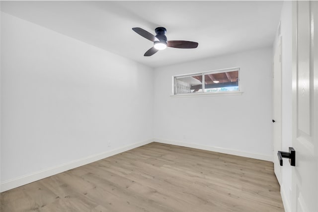 unfurnished room with wood finished floors, a ceiling fan, and baseboards