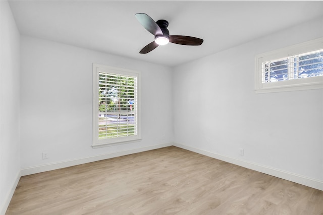 spare room with light wood-style floors, baseboards, and ceiling fan