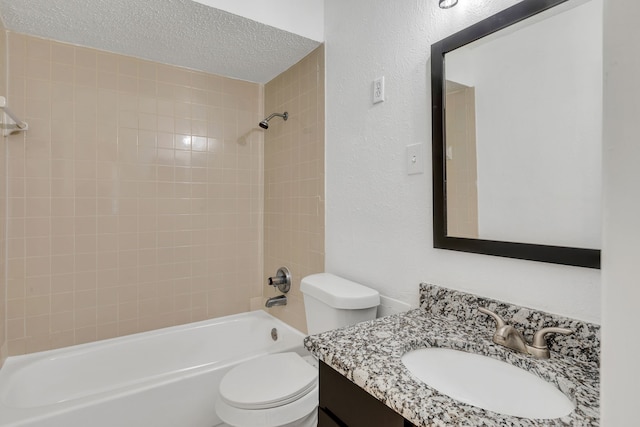 full bathroom featuring vanity, toilet, tiled shower / bath combo, and a textured ceiling