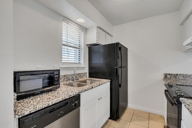 kitchen with sink, black appliances, white cabinetry, and a textured ceiling