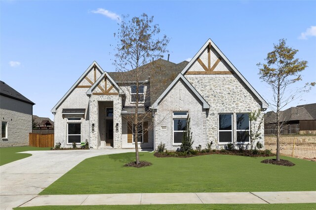 2614 Shadybrook Dr, Celina, TX 75009 - view of front of property with fence, a front lawn, and stone siding