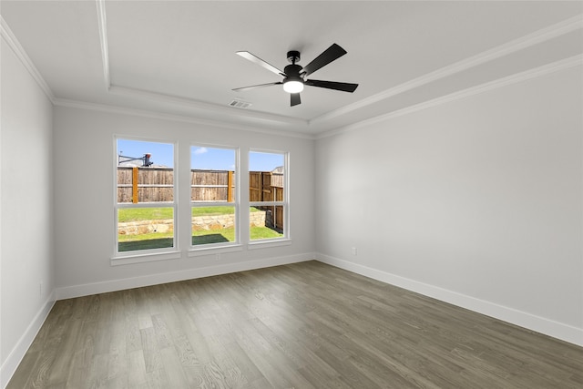 unfurnished room with crown molding, hardwood / wood-style flooring, a healthy amount of sunlight, and ceiling fan