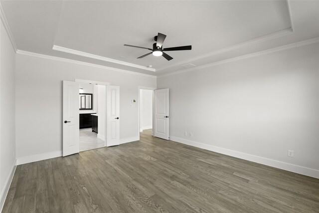 2614 Shadybrook Dr, Celina, TX 75009 - unfurnished bedroom with baseboards, a tray ceiling, and wood finished floors