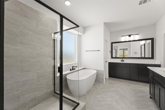 2614 Shadybrook Dr, Celina, TX 75009 - bathroom featuring a soaking tub, visible vents, and a shower stall