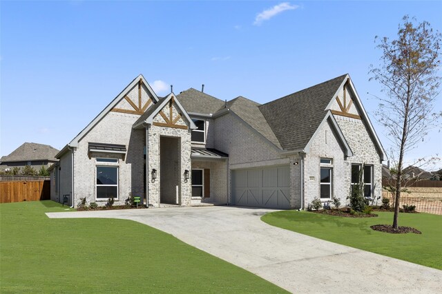 2614 Shadybrook Dr, Celina, TX 75009 - view of front of home with fence, brick siding, driveway, a garage, and a front lawn