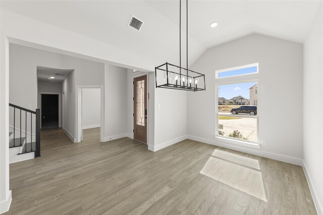2614 Shadybrook Dr, Celina, TX 75009 - unfurnished dining area with lofted ceiling, stairs, wood finished floors, baseboards, and a notable chandelier