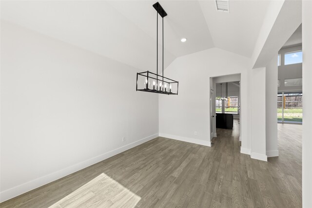 2614 Shadybrook Dr, Celina, TX 75009 - unfurnished dining area with wood finished floors, a chandelier, baseboards, and lofted ceiling