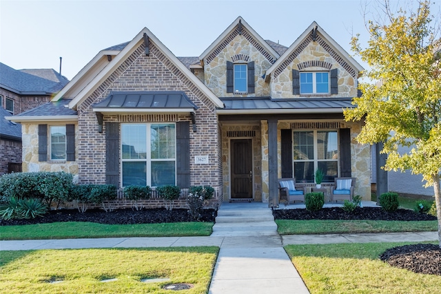 view of front of home with a front lawn and covered porch