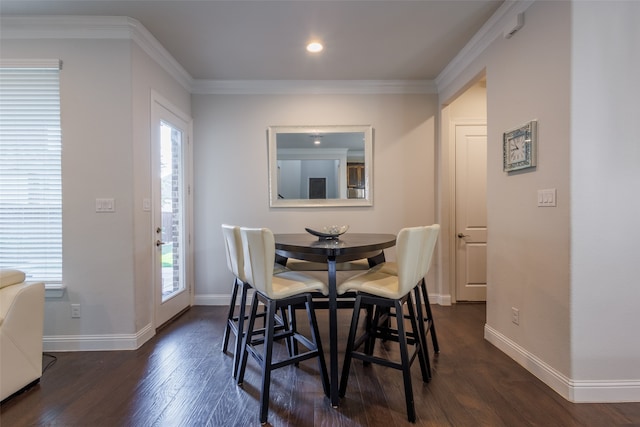 dining area with dark wood-type flooring and crown molding