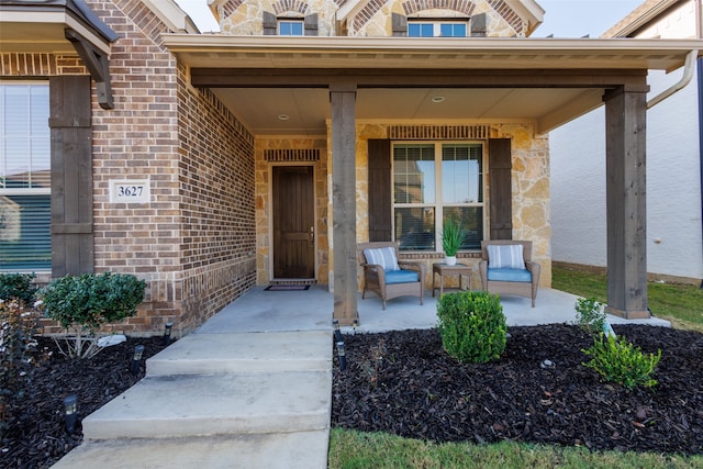 view of exterior entry featuring covered porch