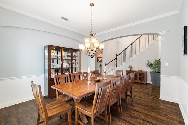 dining space featuring ornamental molding, a chandelier, and dark hardwood / wood-style floors