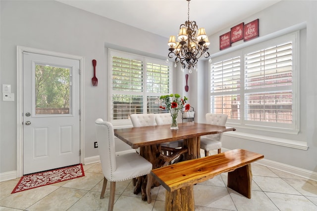 tiled dining space with a notable chandelier and a healthy amount of sunlight