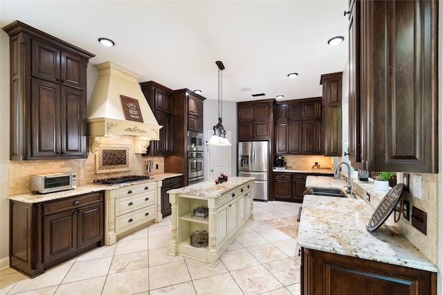 kitchen with custom exhaust hood, cream cabinets, light tile patterned flooring, sink, and stainless steel appliances