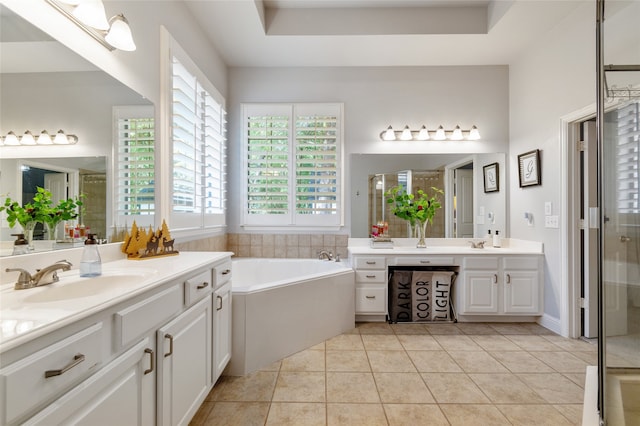 bathroom with vanity, a raised ceiling, independent shower and bath, and tile patterned flooring